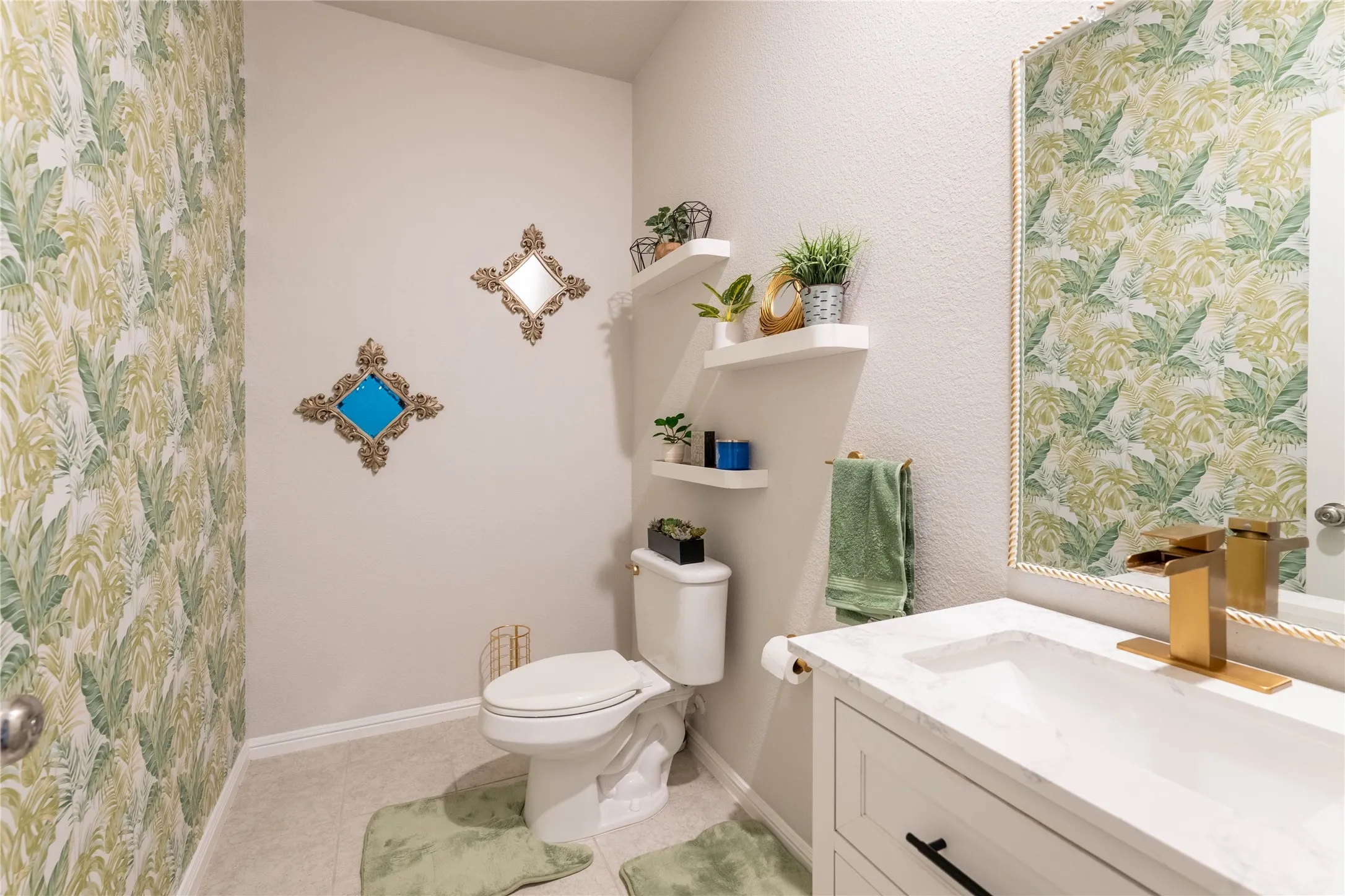 White vanity with a marble-finish countertop and undermount sink