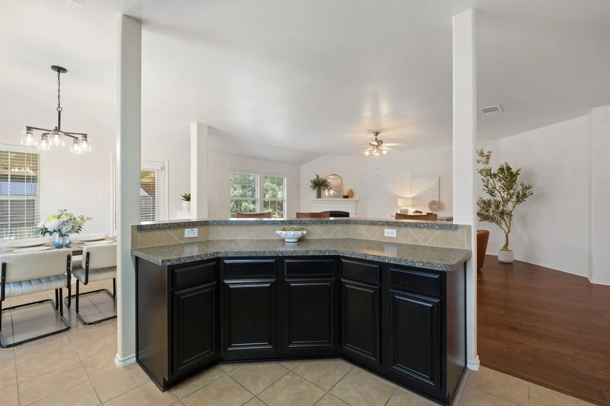 Built-in counter with dark cabinetry, stone-finish countertop, and tile backsplash