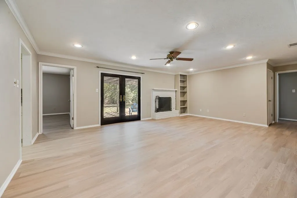 Spacious front living area showcases brand-new LVP flooring, fresh neutral paint and abundant natural light. The open layout provides a versatile blank canvas ready to fit your personal style.