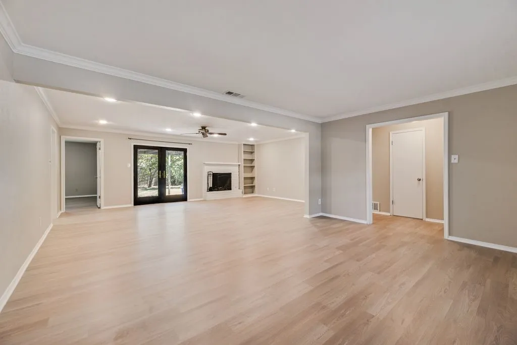 Spacious front living area showcases brand-new LVP flooring, fresh neutral paint and abundant natural light. The open layout provides a versatile blank canvas ready to fit your personal style.