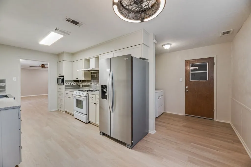 The kitchen opens to a dedicated dining area with direct backyard access, offering an easy flow for everyday meals and entertaining. Refrigerator is negotiable, giving buyers the option for an even easier move-in.