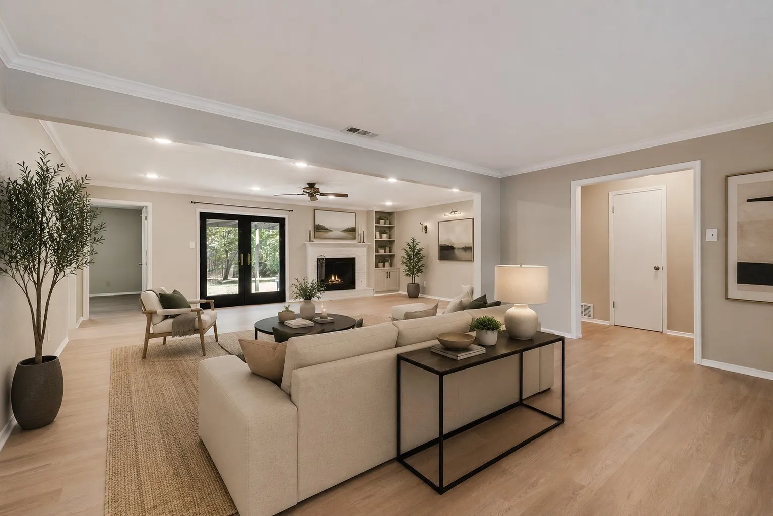 Digitally Staged. Spacious front living area showcases brand-new LVP flooring, fresh neutral paint and abundant natural light. The open layout provides a versatile blank canvas ready to fit your personal style.