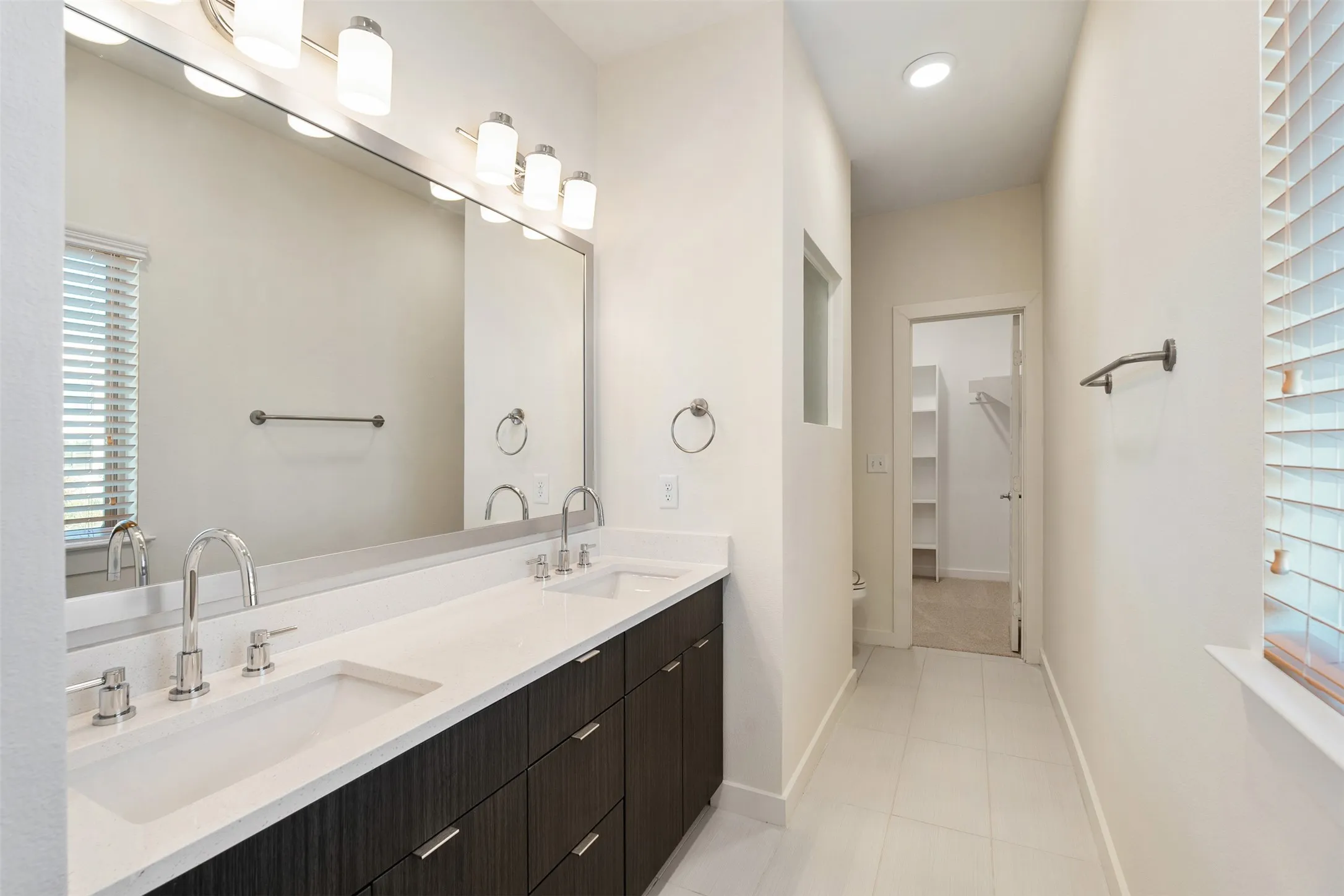 Dual vanity with integrated sinks and brushed nickel fixtures