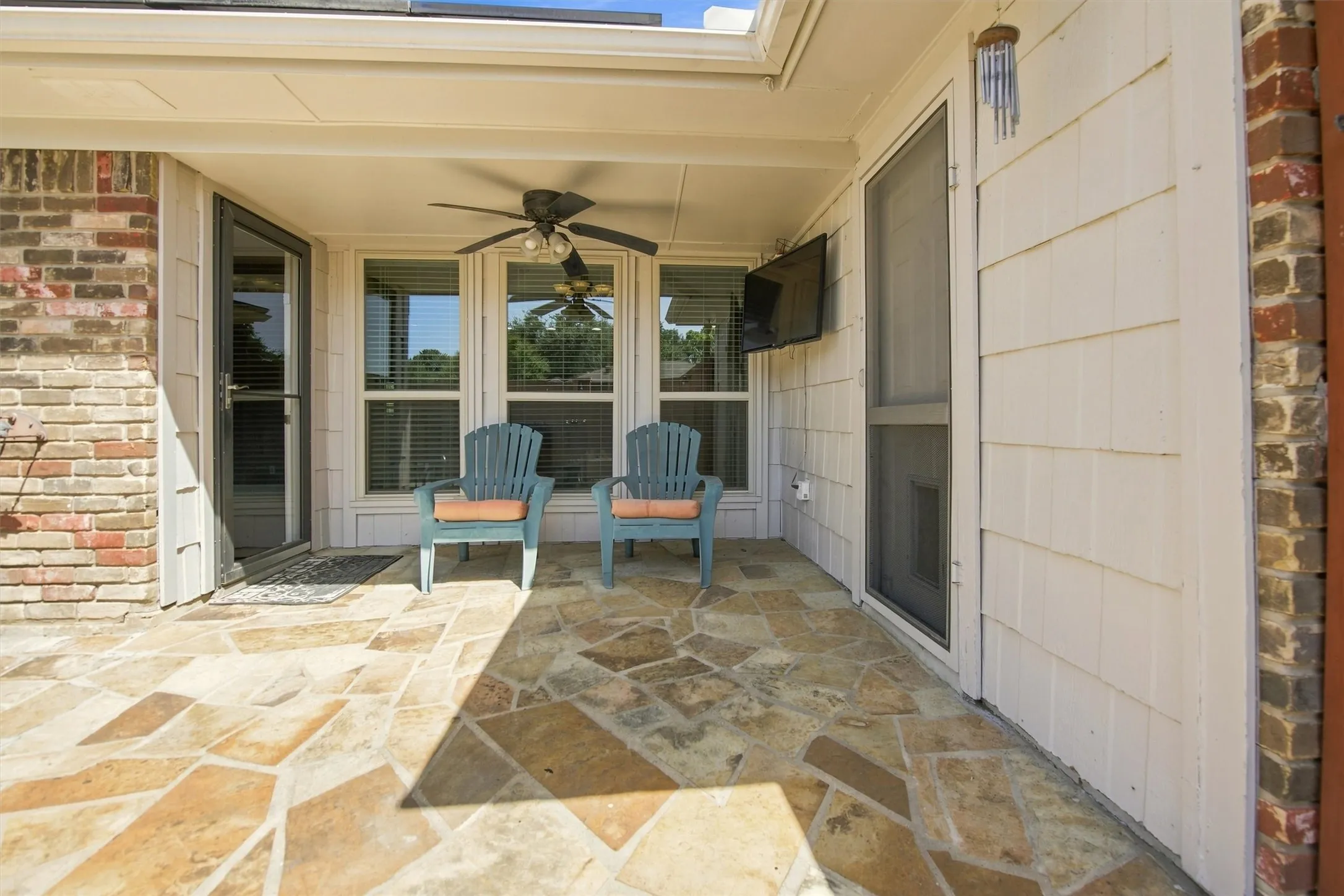 Ceiling fan and TV on back patio.