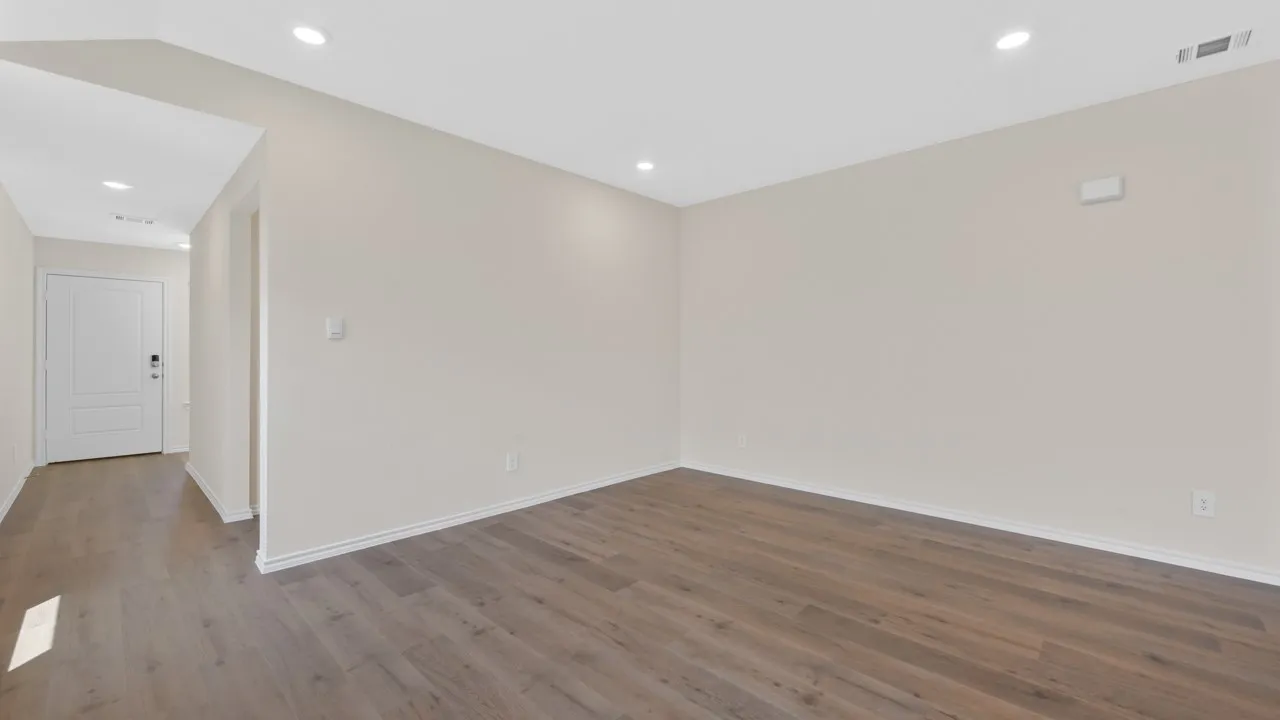 Recessed lighting, wood-finish flooring, light-toned walls, and white baseboards