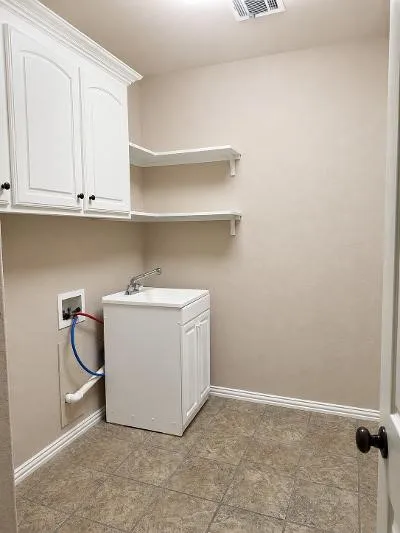 Utility Room with sink and room for an extra refrigerator
