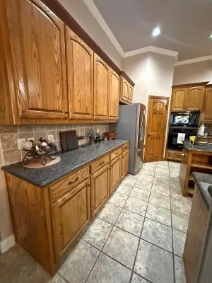 large Kitchen with gorgeous cabinets galore.