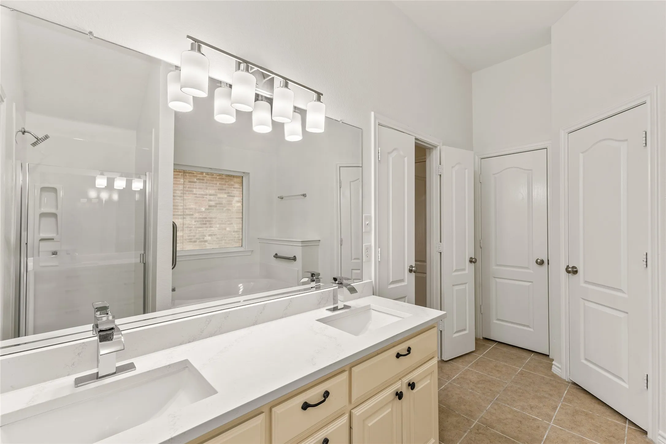 Dual vanity with integrated sinks, white countertops, and chrome fixtures
