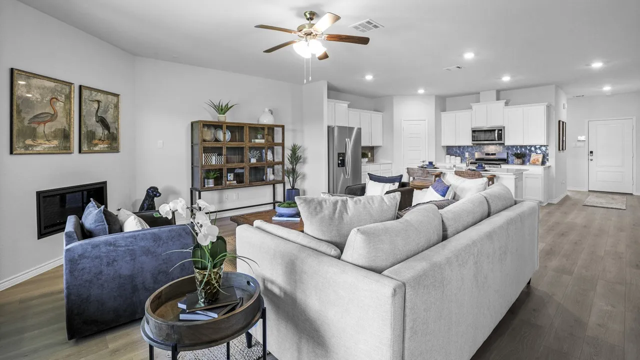 Open-concept living area featuring wood-finish flooring, recessed lighting, and a ceiling fan