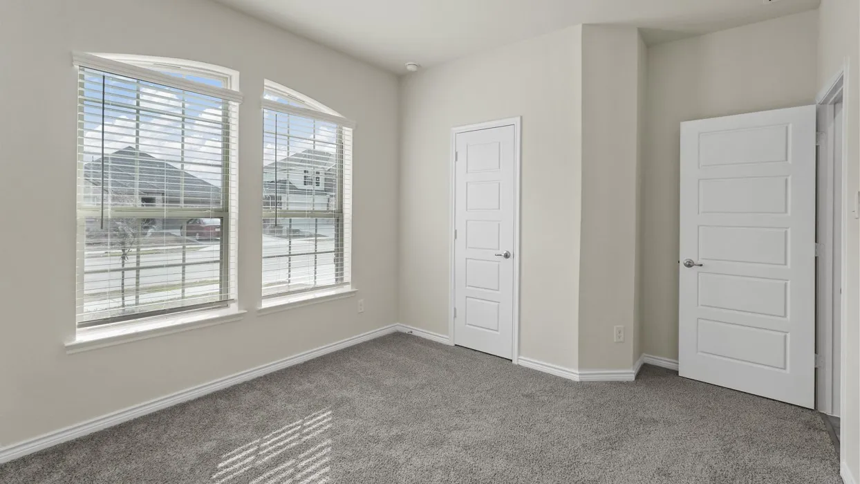 Arched windows, contemporary interior doors, neutral wall paint, and gray carpet flooring