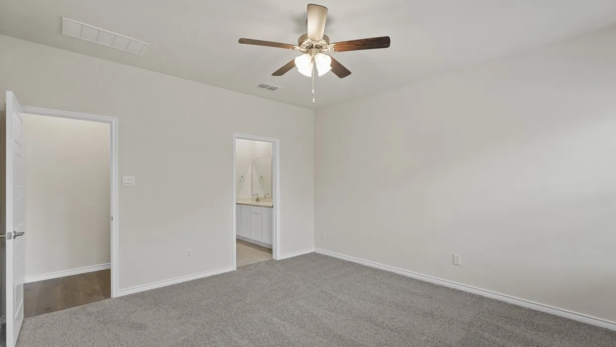 Light gray carpeted flooring, neutral wall paint, and a ceiling fan with integrated lighting