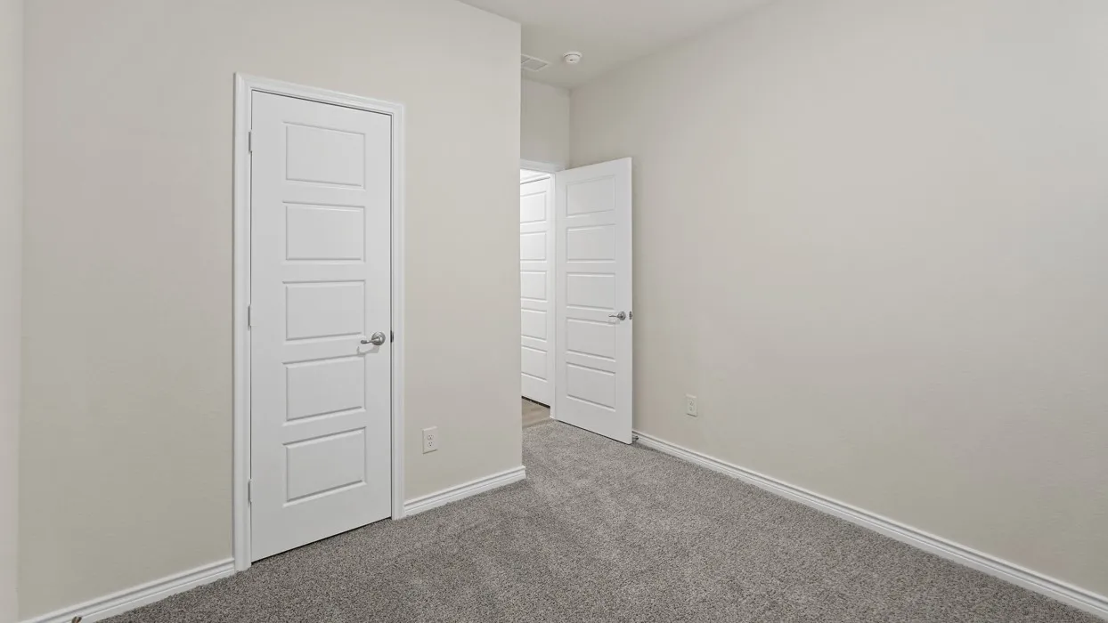 Neutral wall paint, plush carpeting, white interior doors with contemporary panels, and brushed nickel hardware