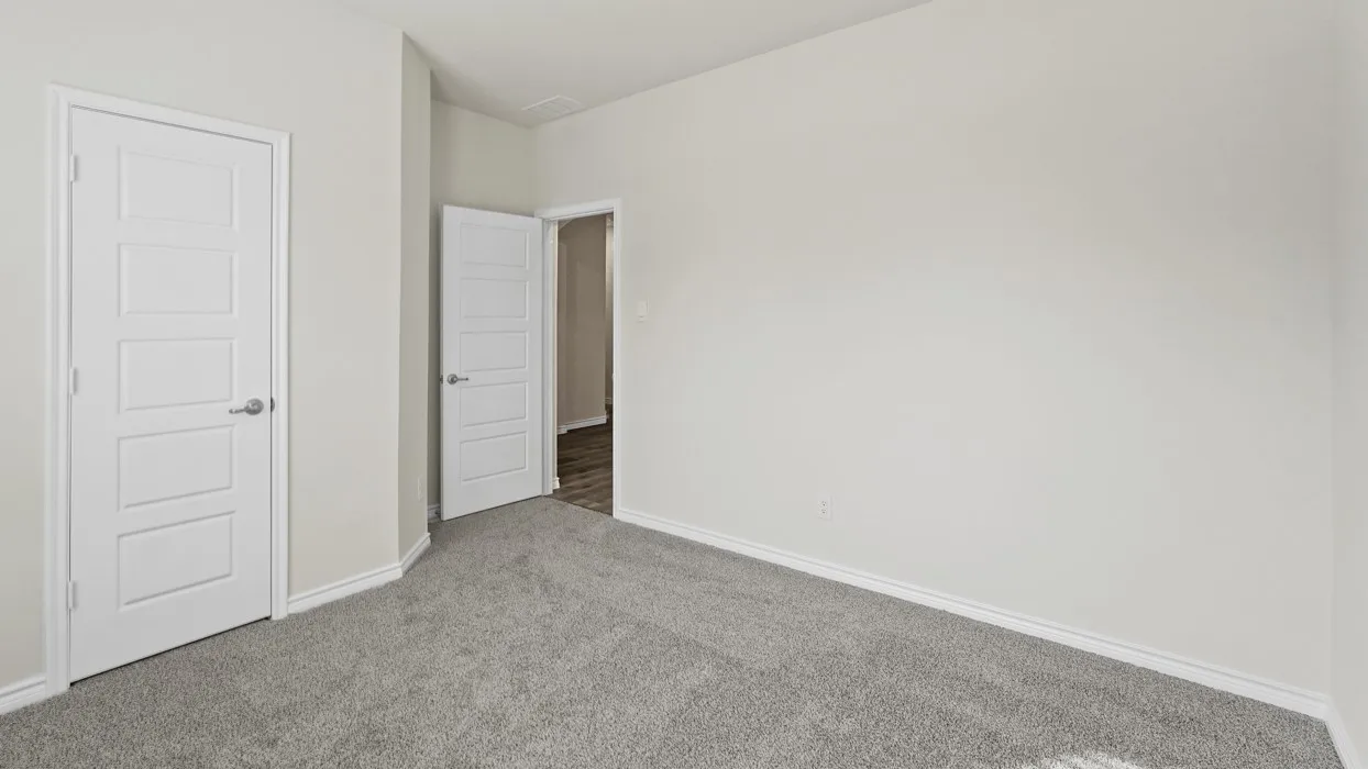 Light gray wall paint, light gray carpeting, five-panel interior doors, brushed nickel hardware, and white trim