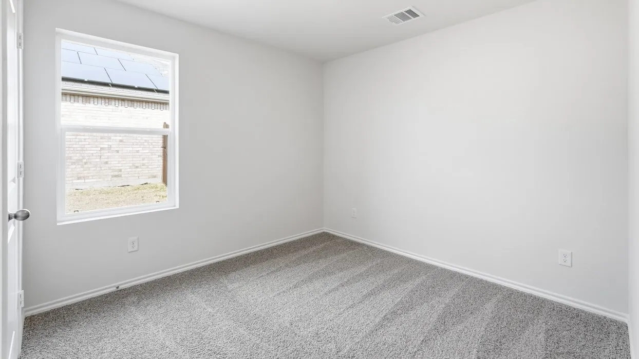 White painted walls and gray carpet flooring