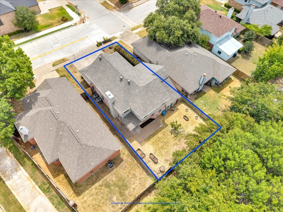 Expansive property with a gabled roof, brick exterior, and a paved patio area