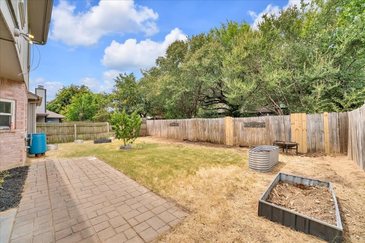 Brick paver patio with a fenced backyard