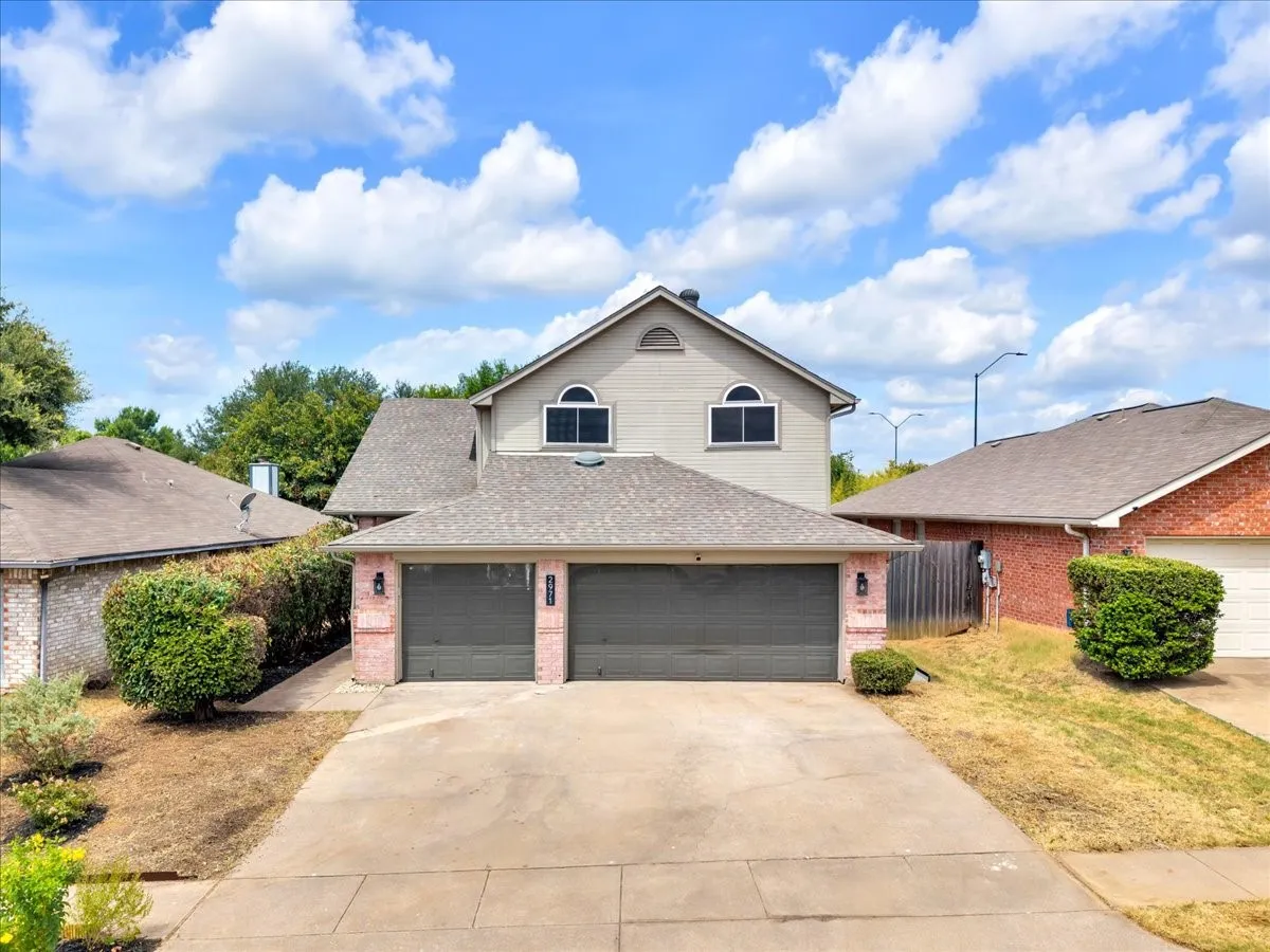 Two-story residence featuring a two-car garage and a concrete driveway