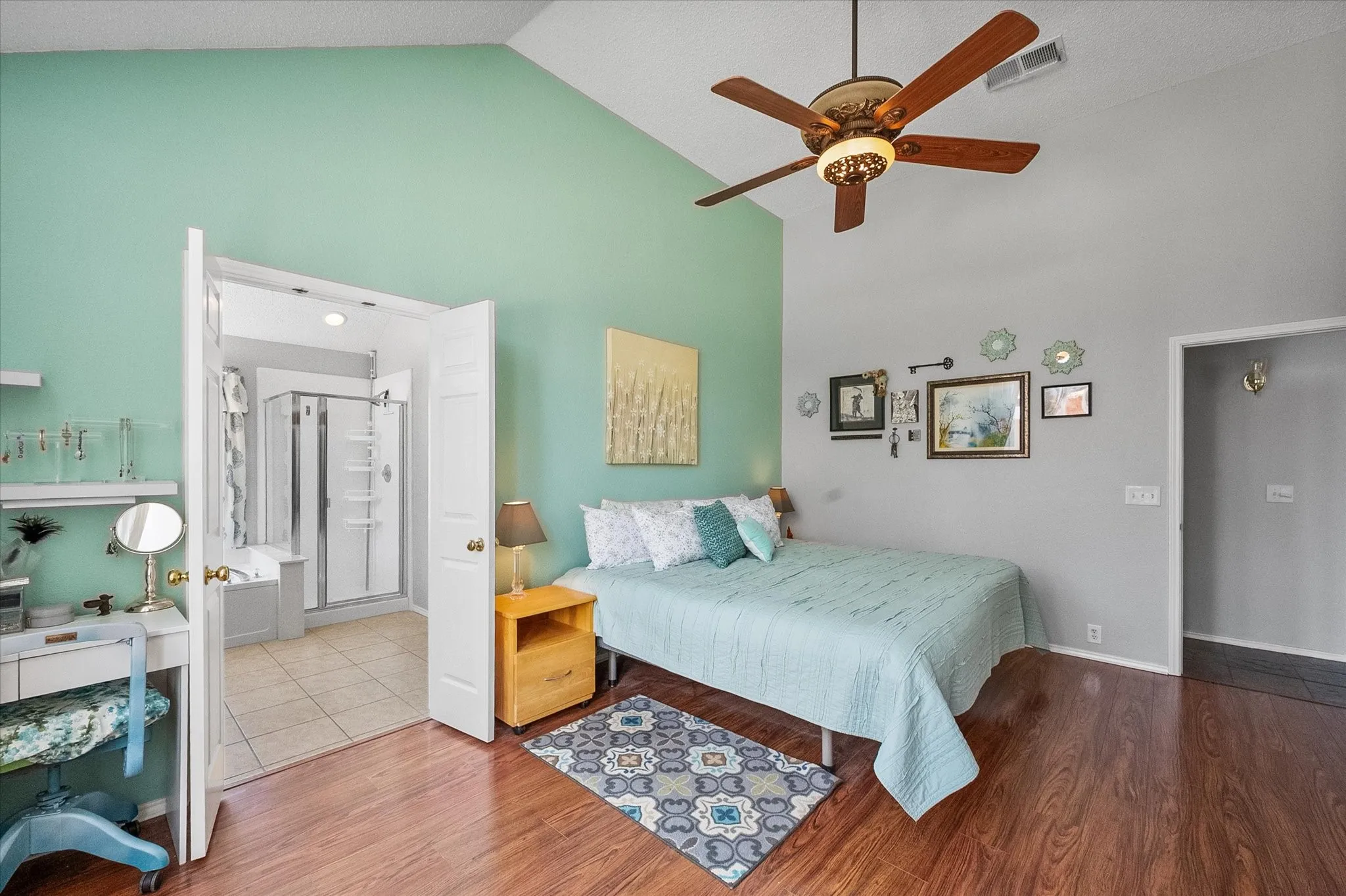 Spacious primary bedroom with vaulted ceilings.
