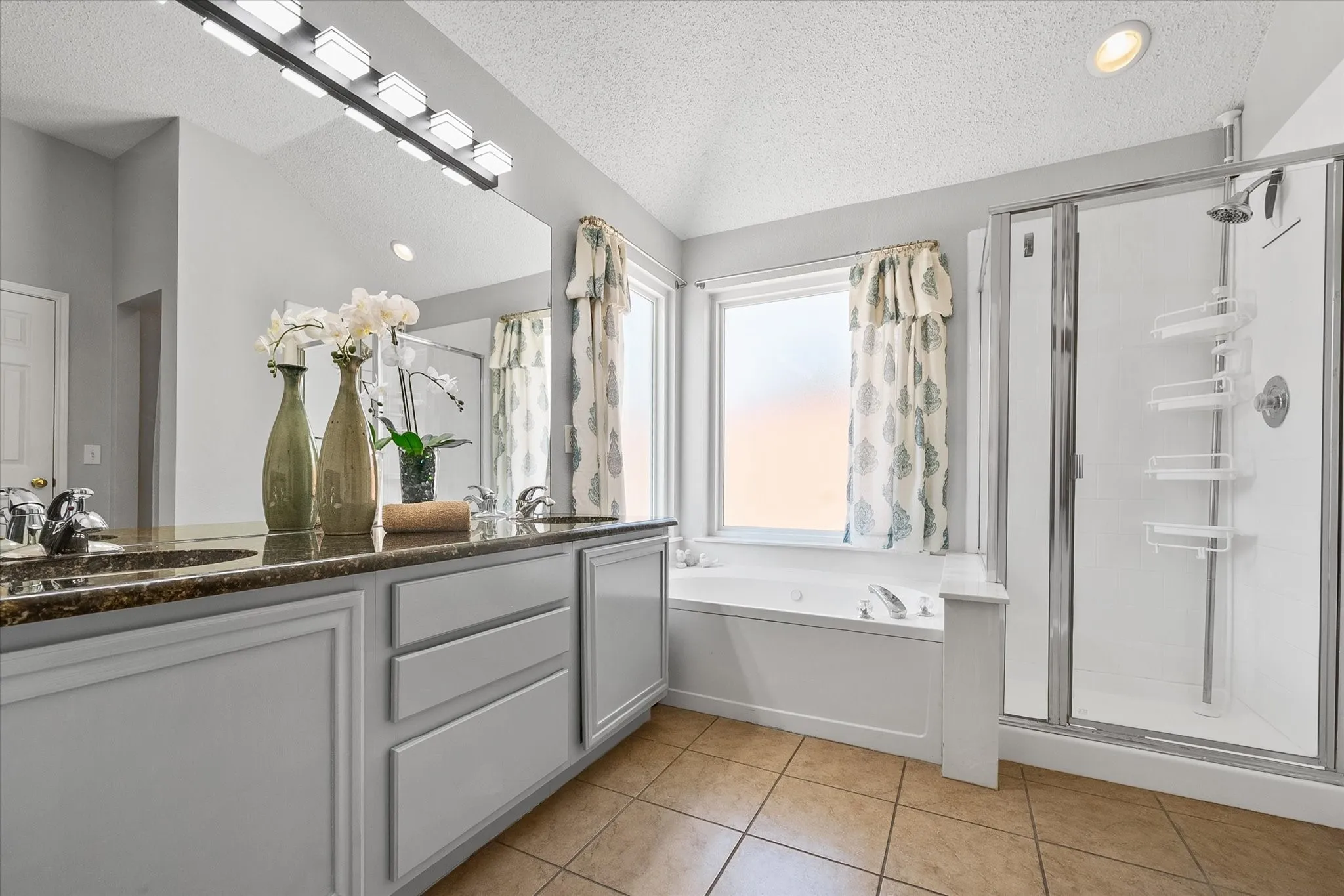 Primary bathroom offers dual sinks, soaking tub and a shower!