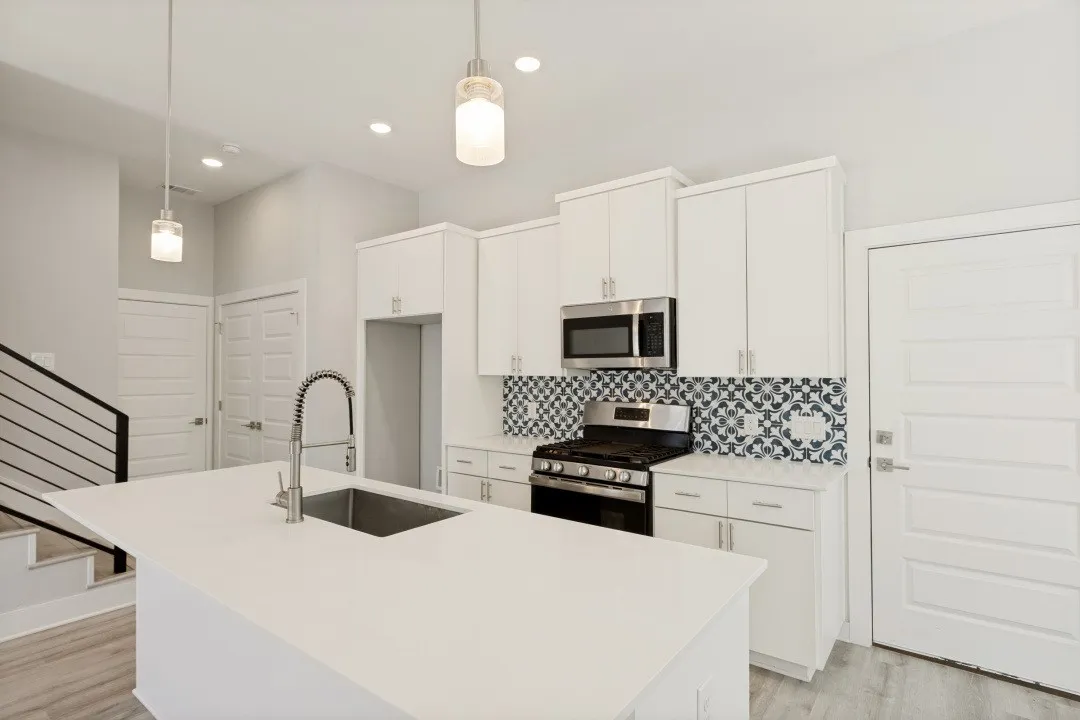 Kitchen island with an undermount sink and gooseneck faucet
