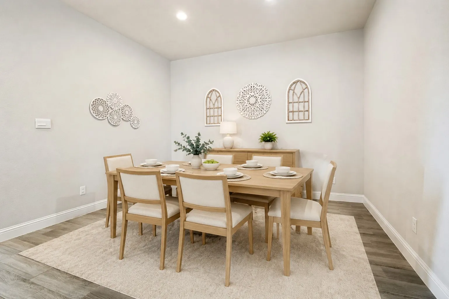 **Virtually staged for effect**Recessed ceiling lighting, light gray wall color, white trim, wood-finish flooring, and a built-in sideboard