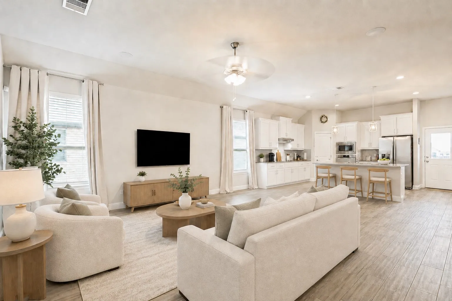 **Virtually staged for effect** Open-concept living space with wood-finish flooring, vaulted ceilings, and a ceiling fan
