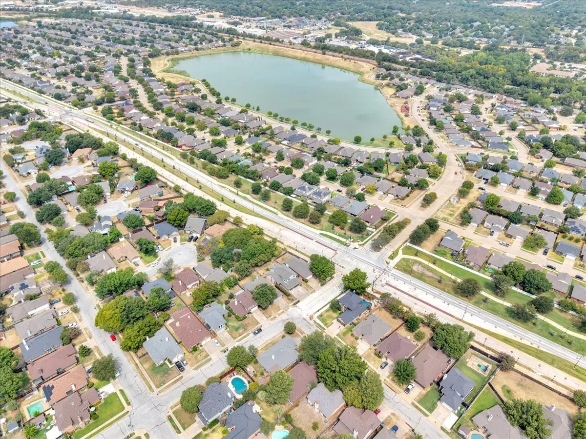 Residential area featuring a lake and established homes