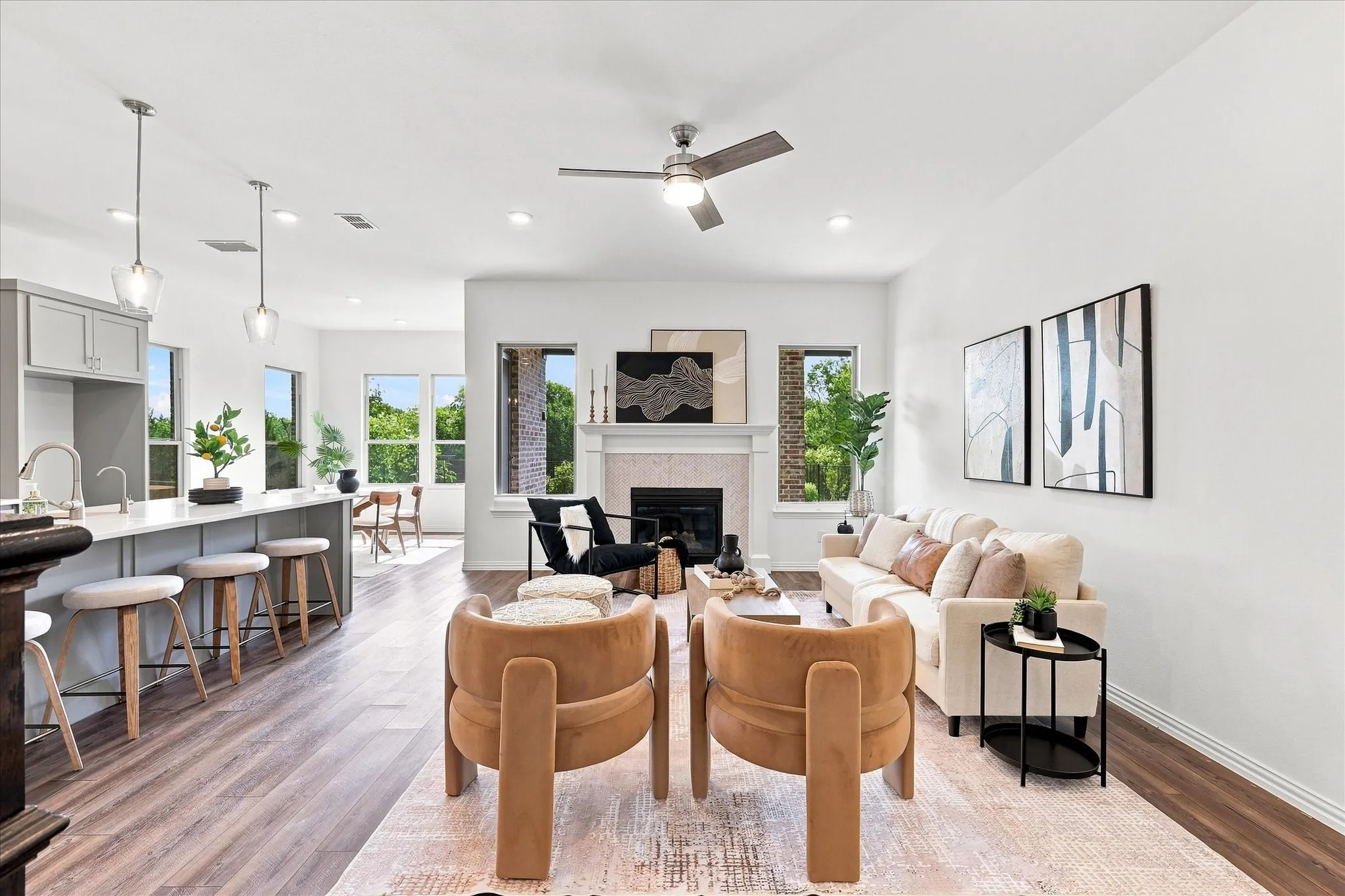 Open concept living space with wood-finish flooring, a contemporary fireplace, and recessed lighting