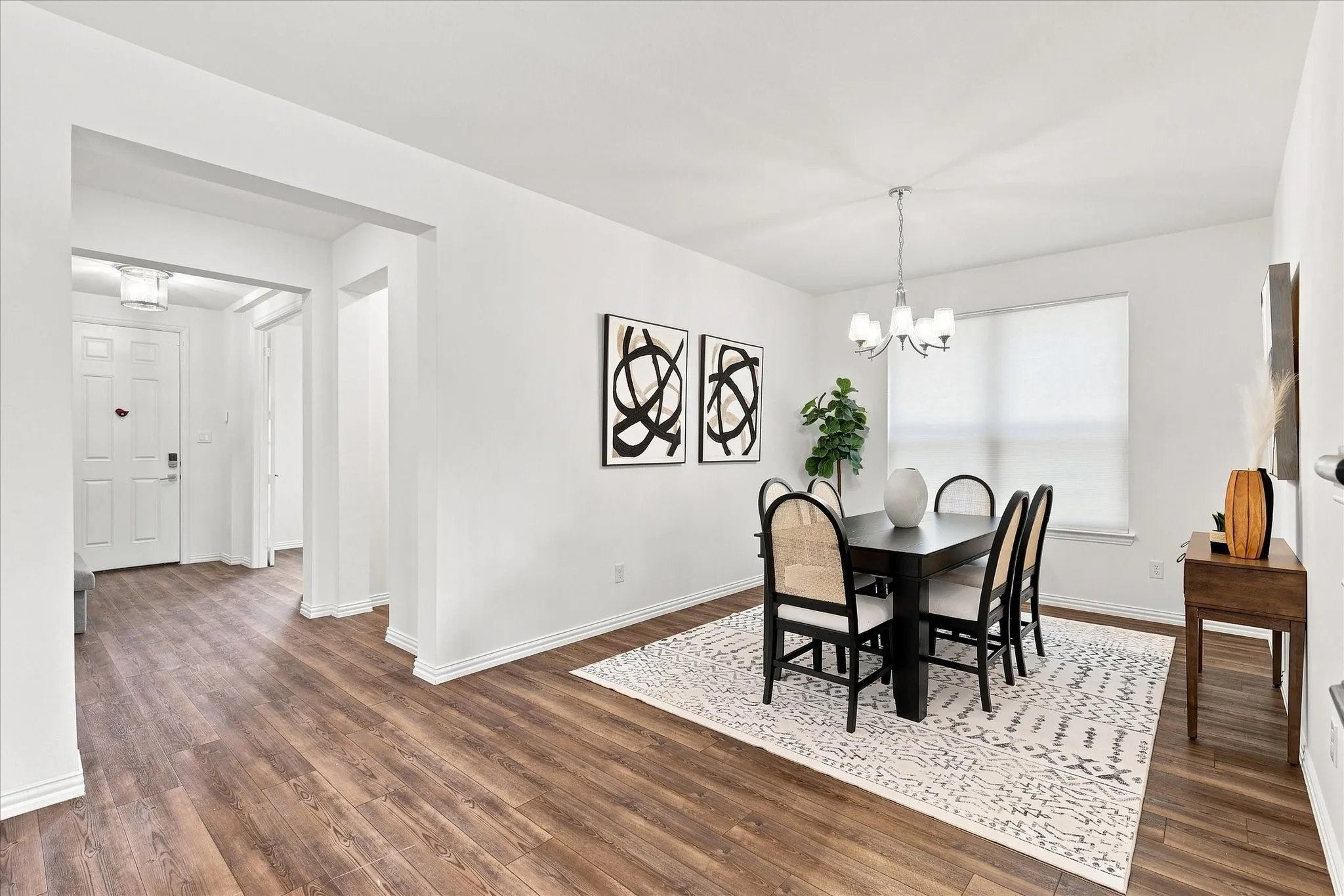 Wood-finish flooring throughout, white walls, and recessed lighting