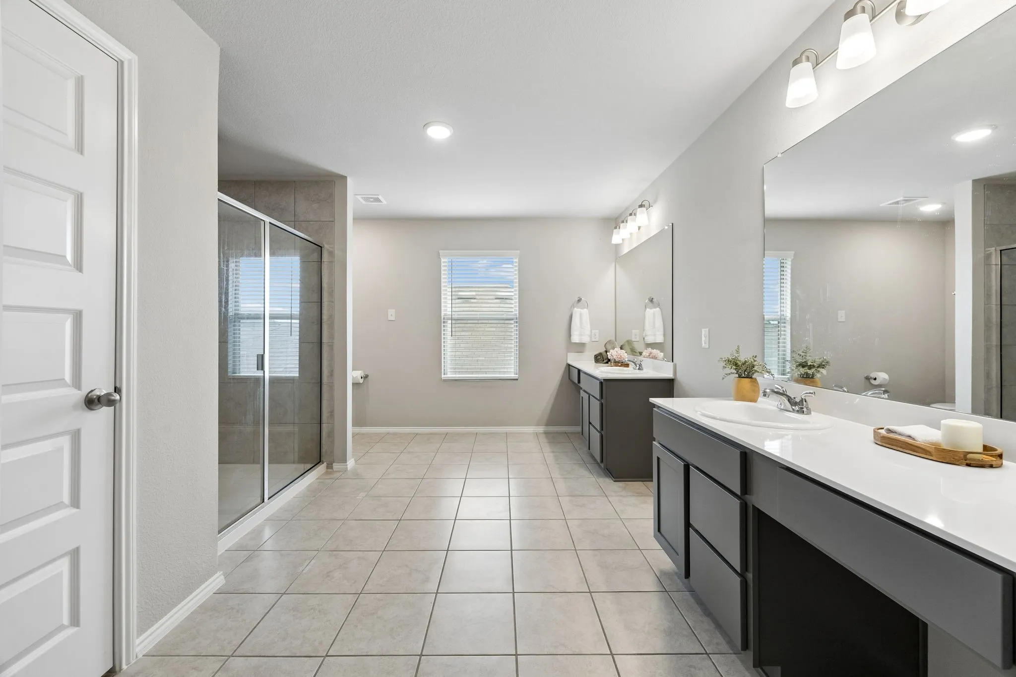 Primary bath includes a large linen closet in addition to two separate walk-in closets.