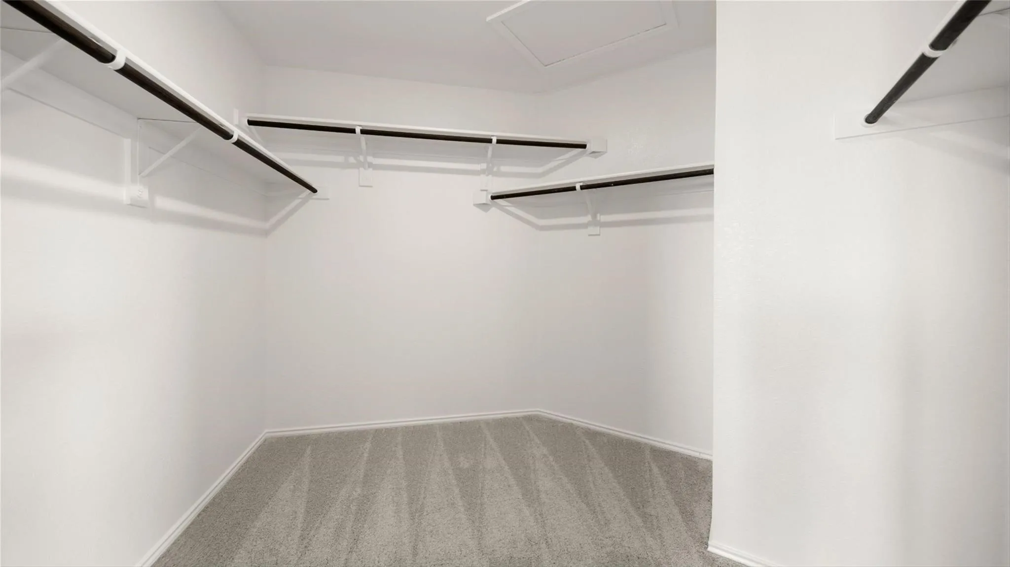 One of two separate walk-in closets serving the primary suite.