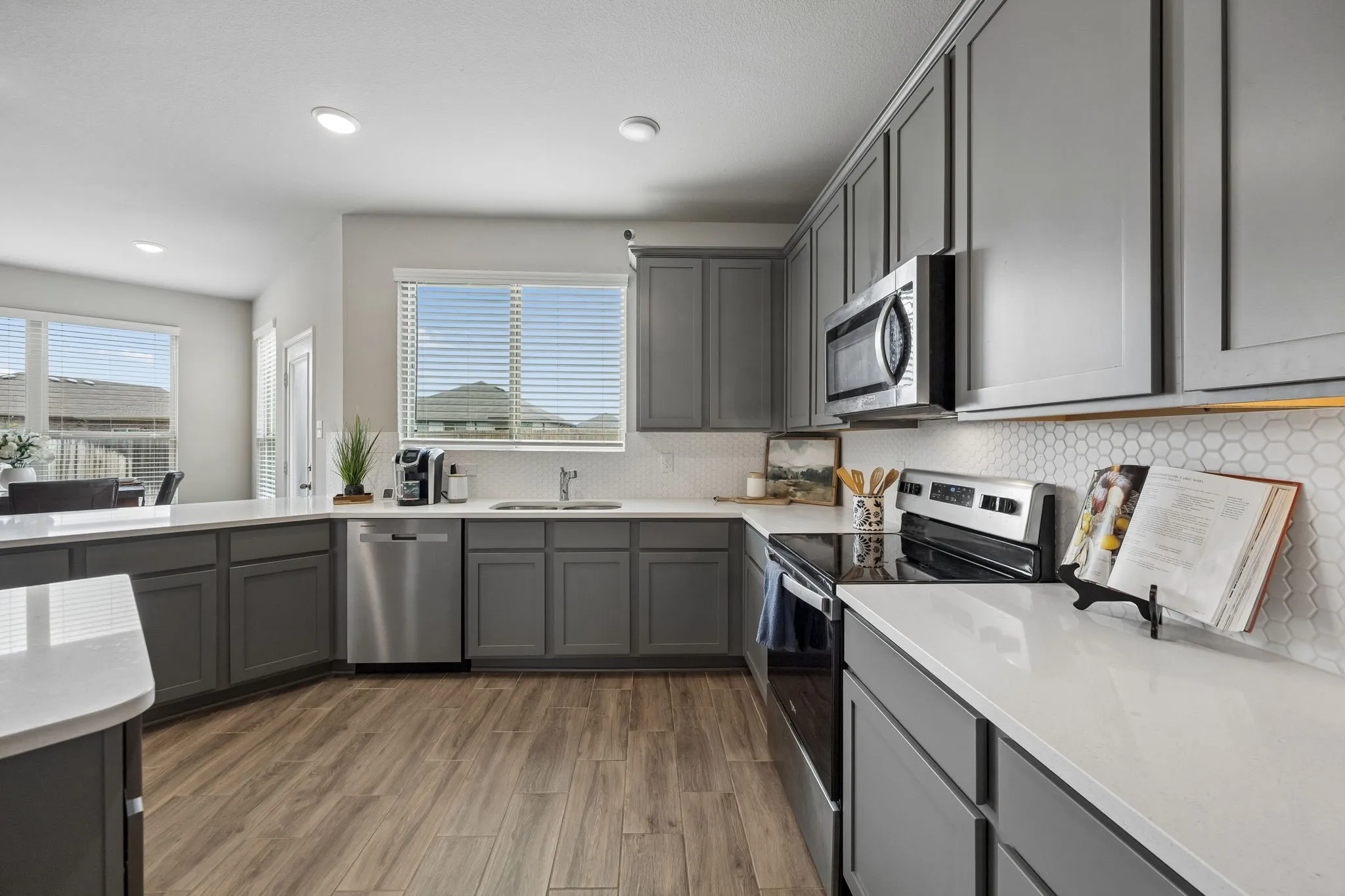 The kitchen sink overlooks the backyard while the open layout keeps the kitchen connected to the surrounding living spaces.