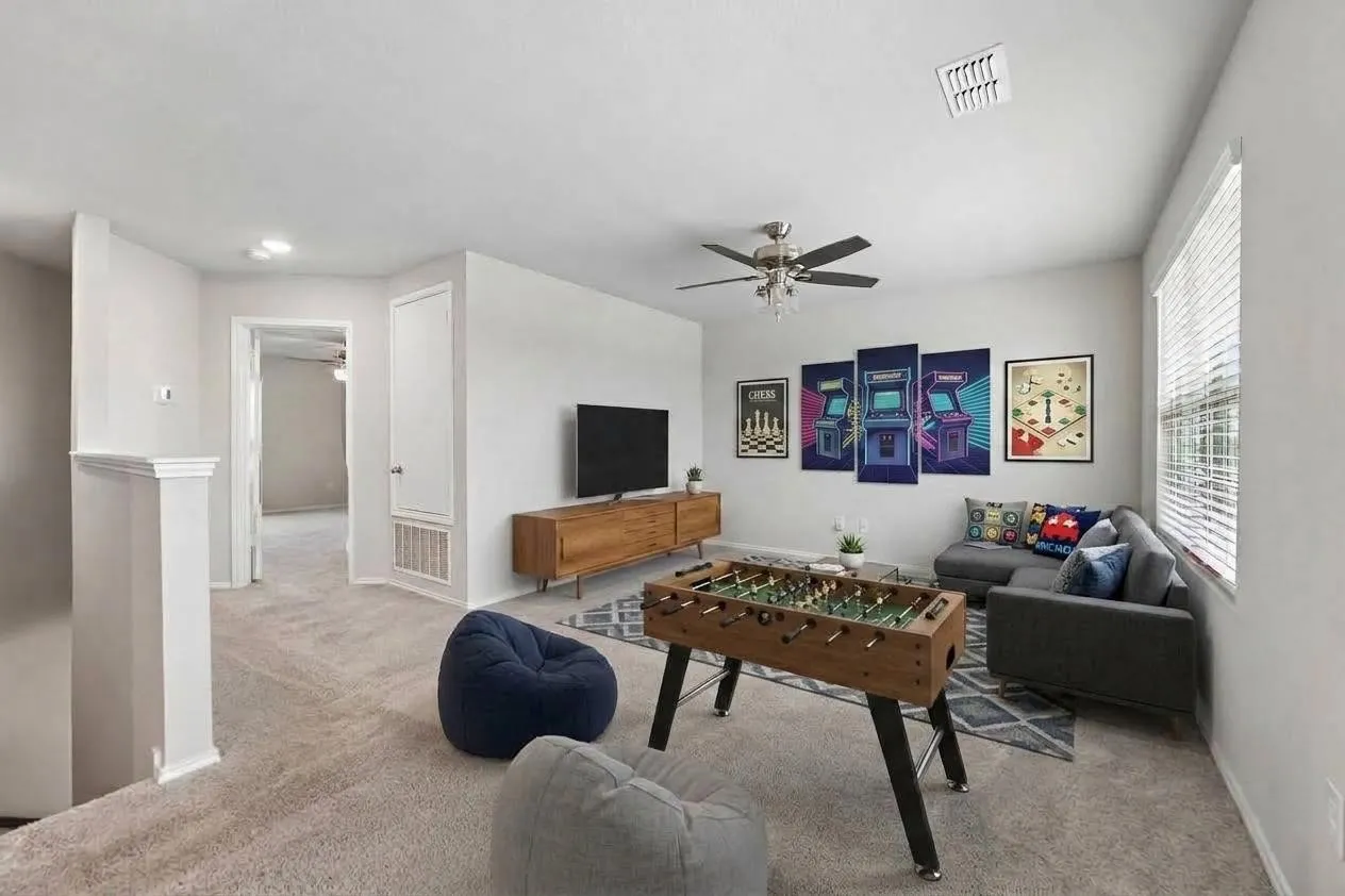 Upstairs game room adds another flexible living space separate from the downstairs gathering areas.