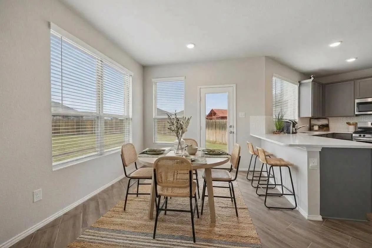 Light-filled breakfast area sits just off the kitchen with backyard access nearby.
