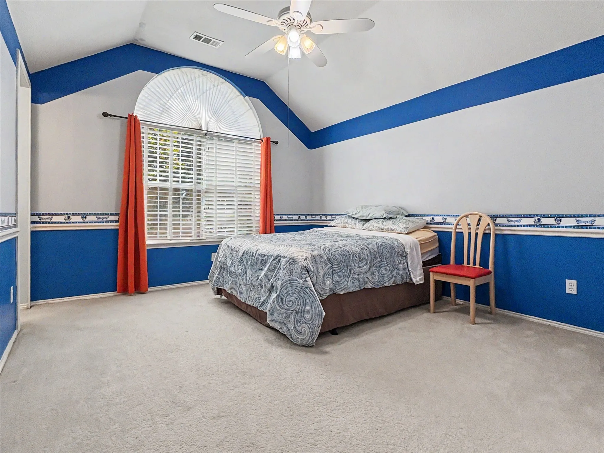 Vaulted ceiling with a ceiling fan, arched window with horizontal blinds, and wall trim detailing