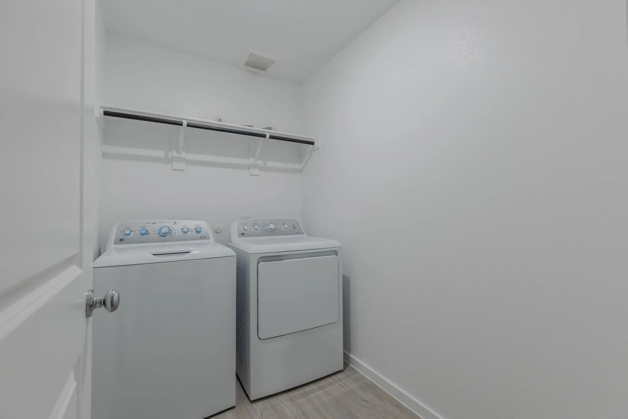 Washroom featuring light hardwood / wood-style floors and washer and clothes dryer