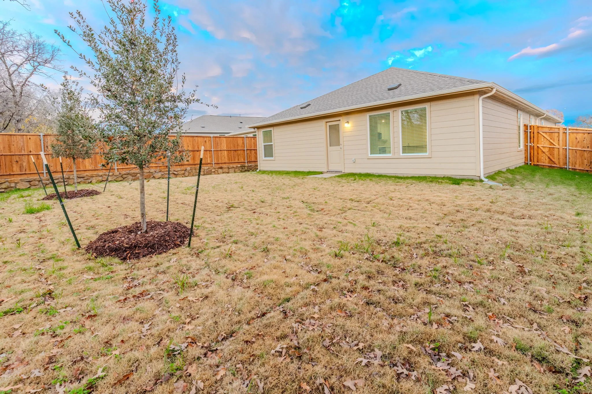 Back of house with a yard