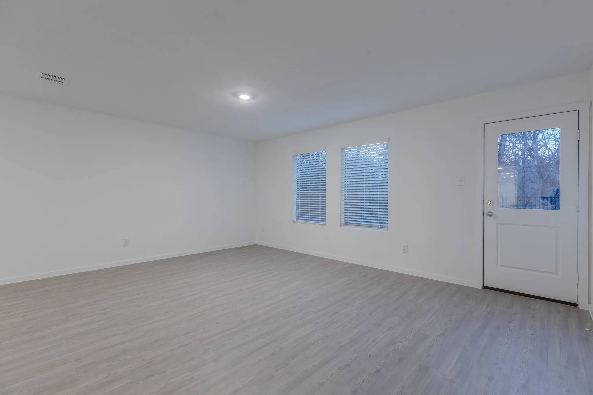 Spare room featuring light hardwood / wood-style flooring and plenty of natural light