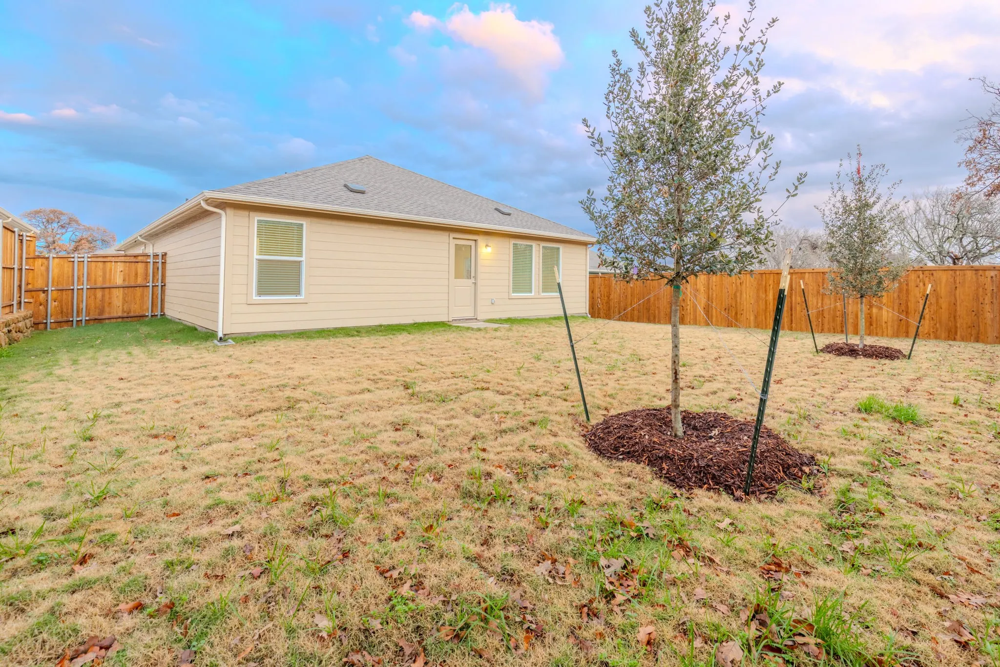 Back of house with a lawn