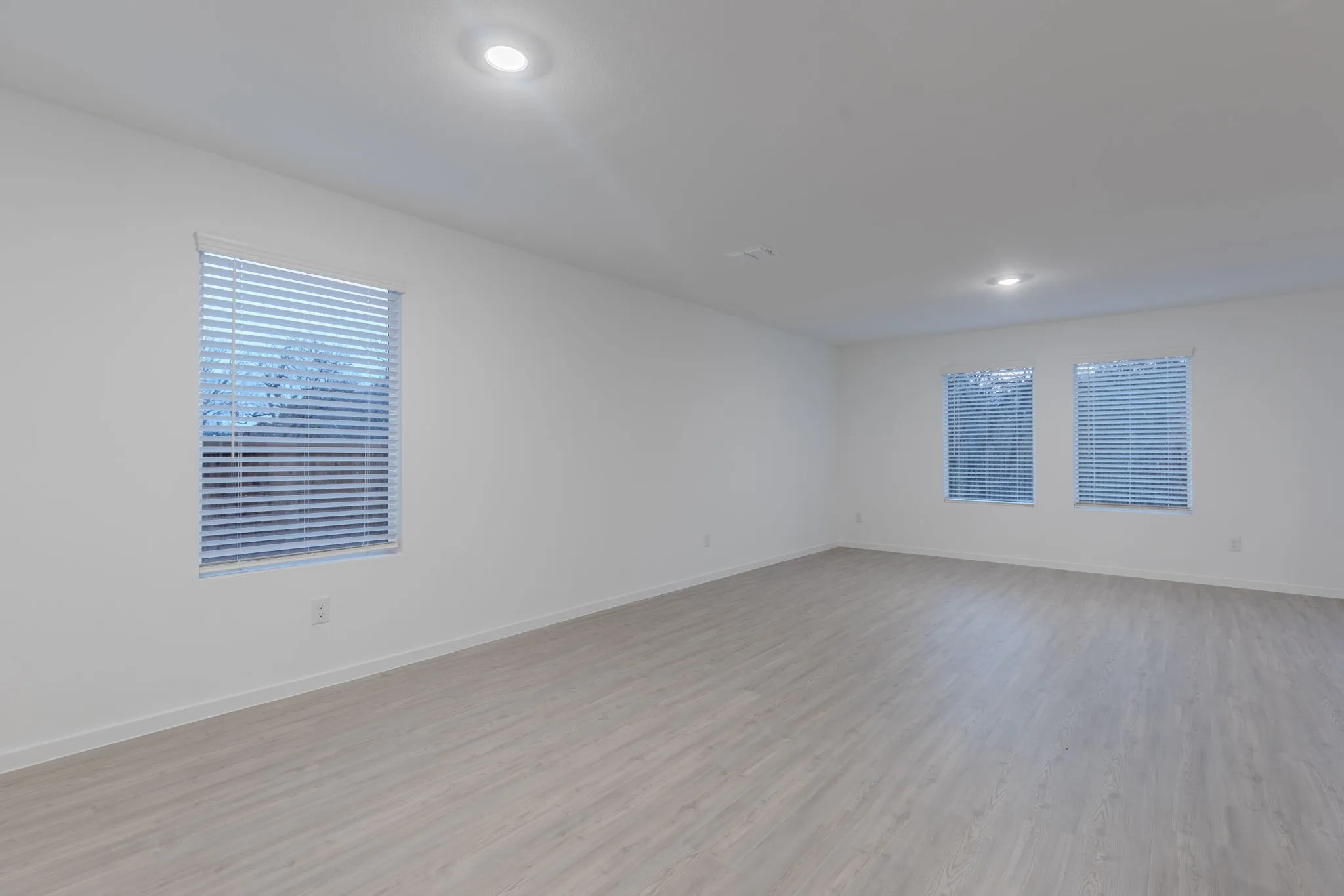 Empty room with light hardwood / wood-style flooring