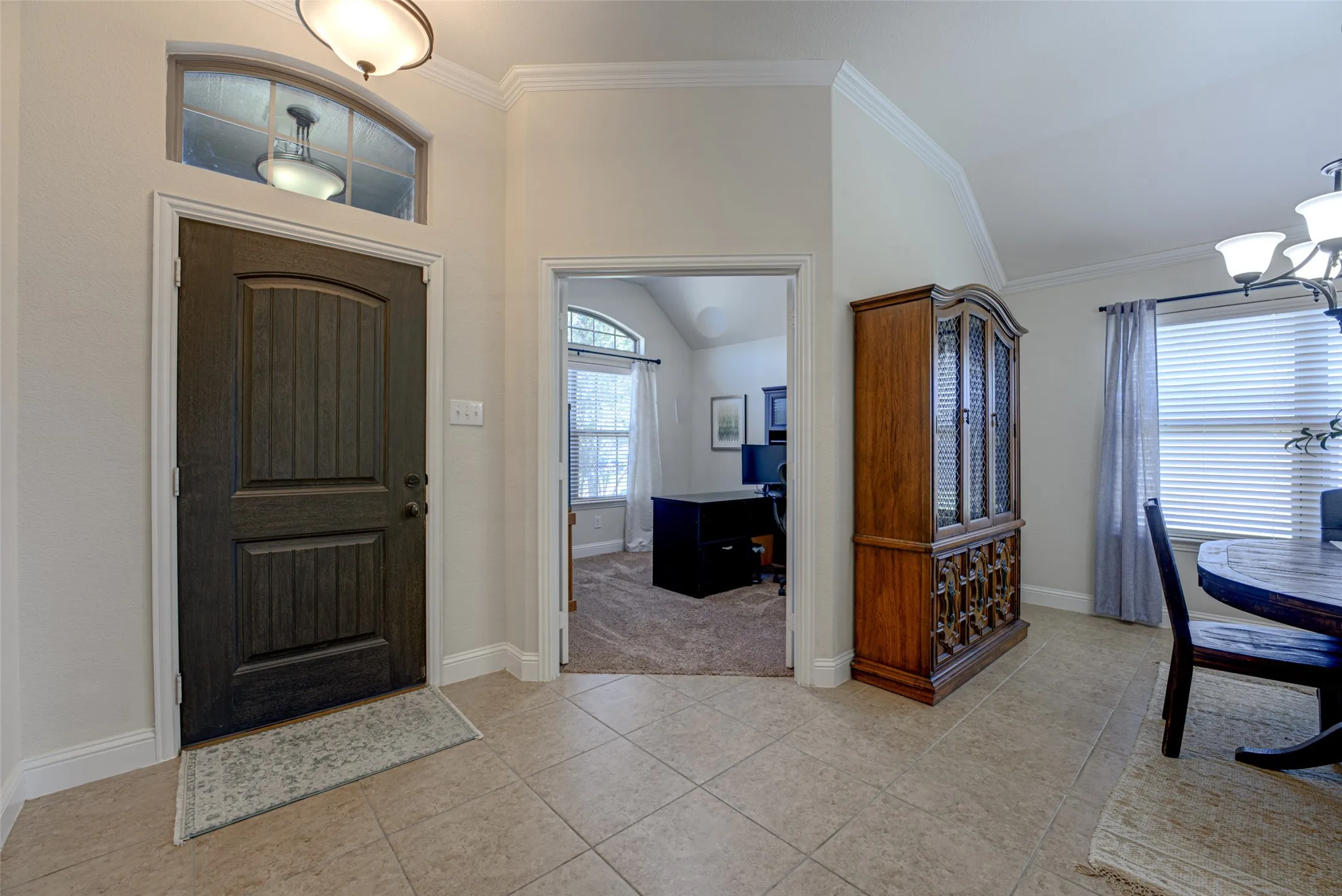 View from front entrance of home office and formal dining room.