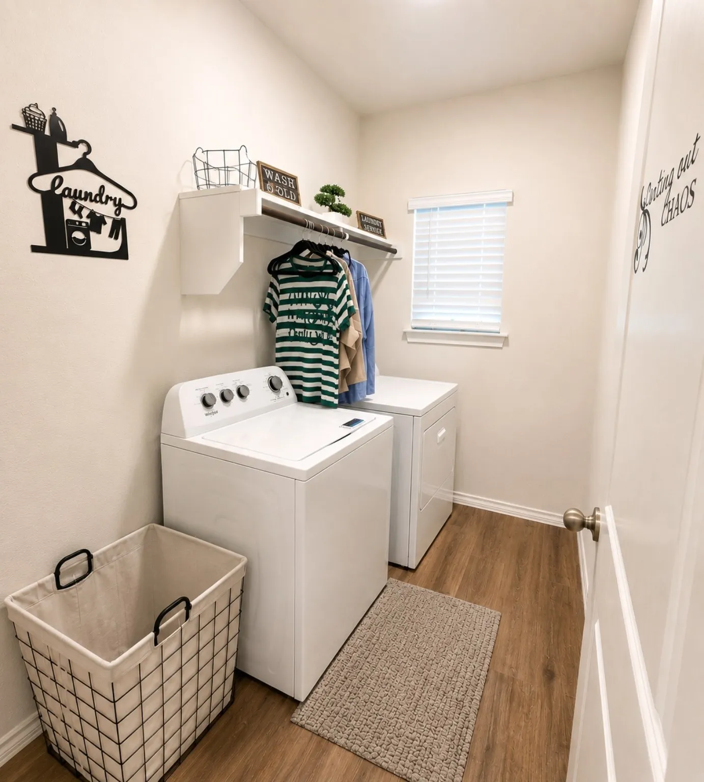 Laundry area with wood-finish flooring, white walls, and a window with blinds
