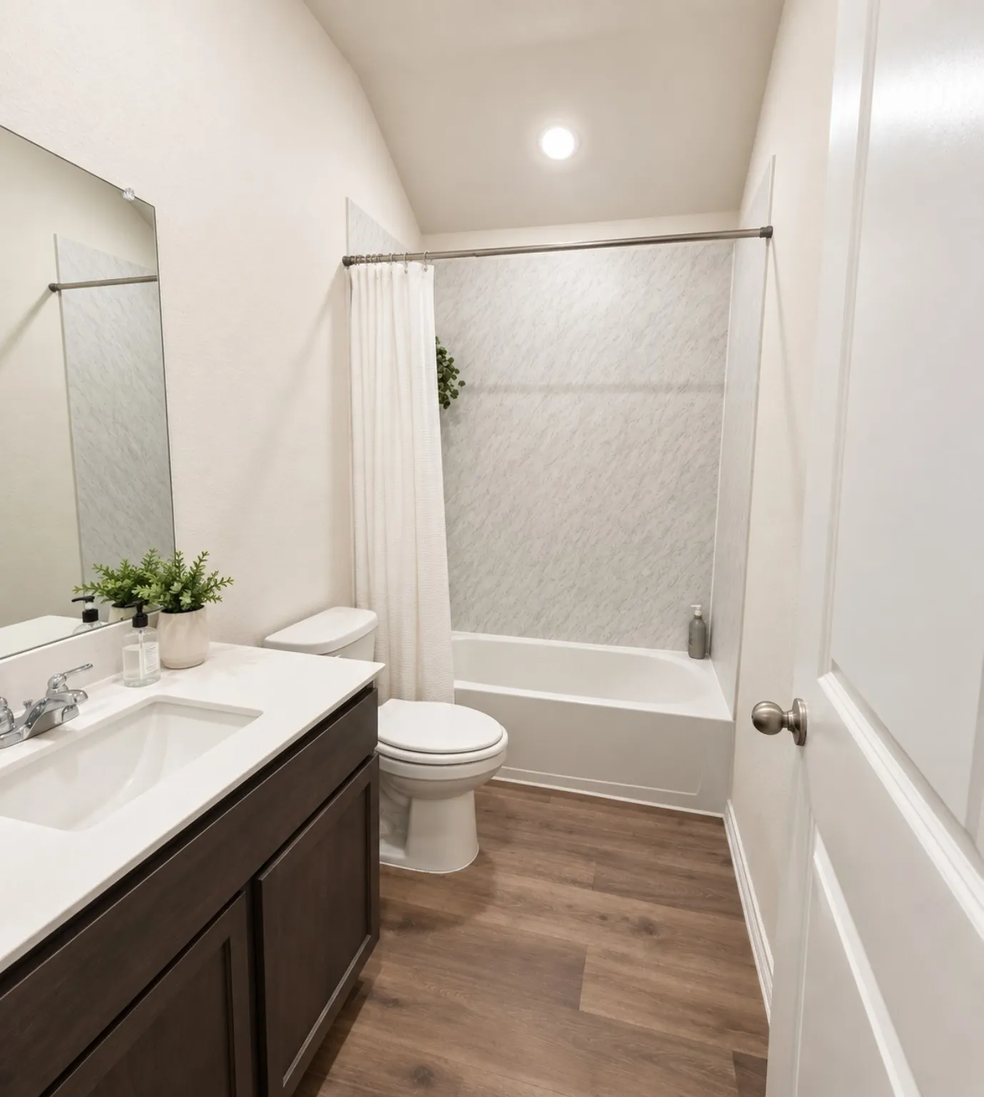 Dark wood-finish vanity with a white countertop and undermount sink