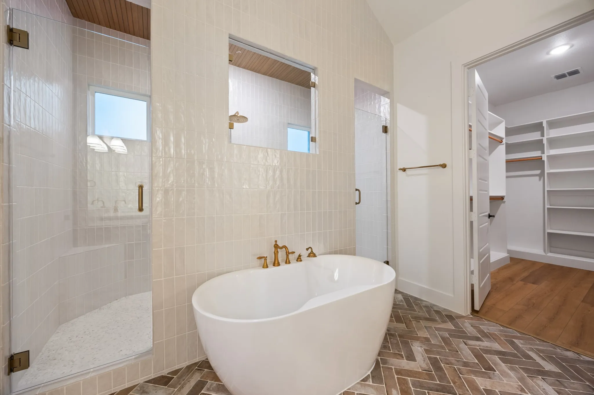 Bathroom featuring stall Shower, a free standing bath, special closet plus decorative tiling!
