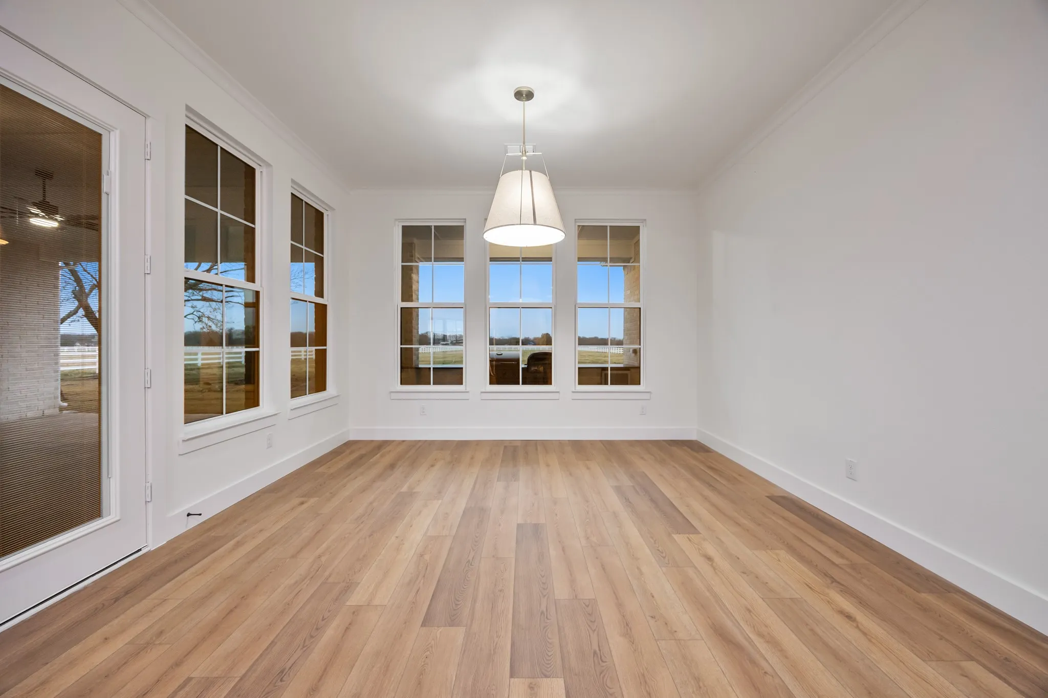 Primary Bedroom with Light Wood-Type Flooring and lots of Windows with Views!