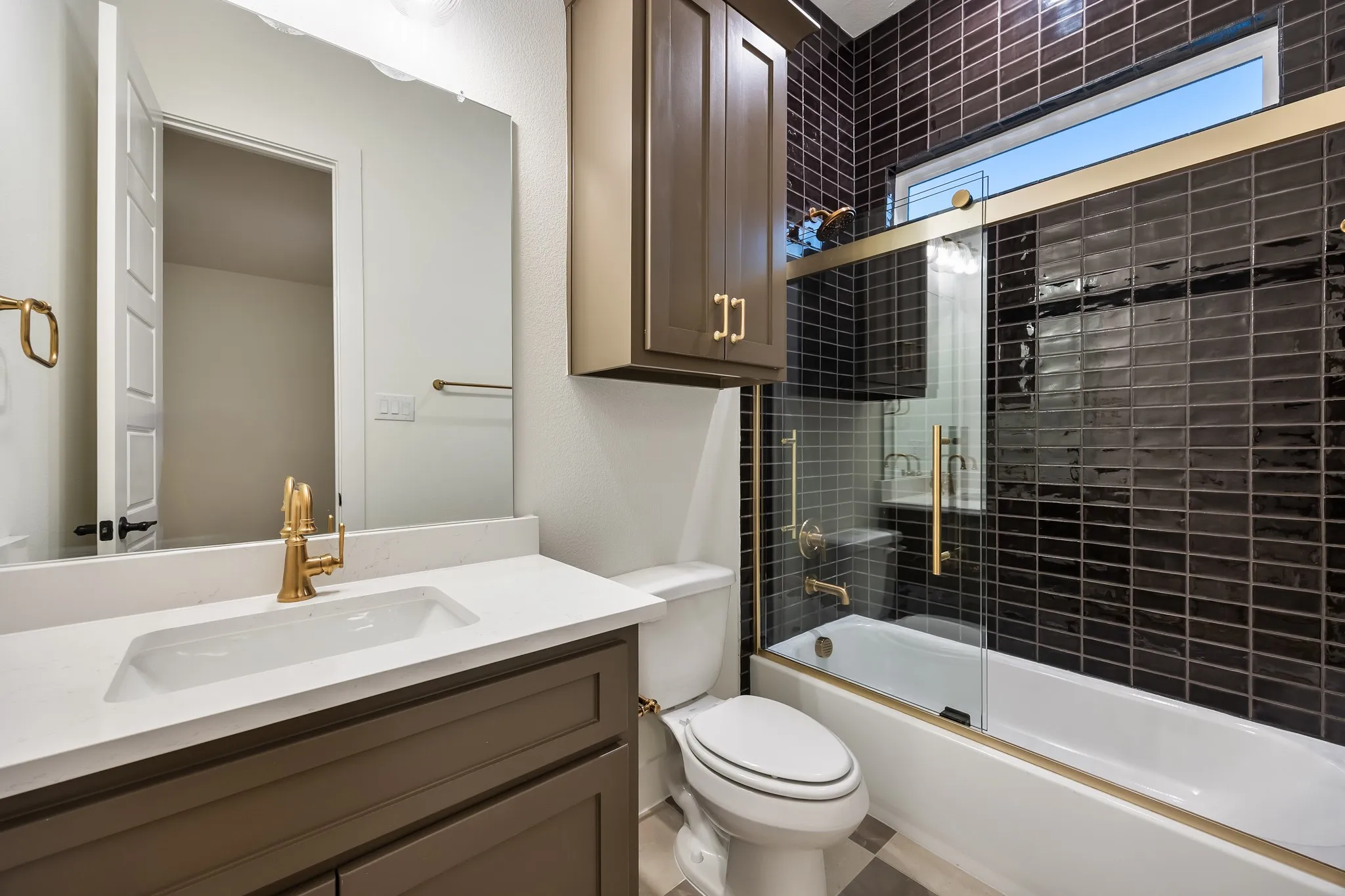 Bathroom with Shower/bath combination with glass doors & quartz vanity!
