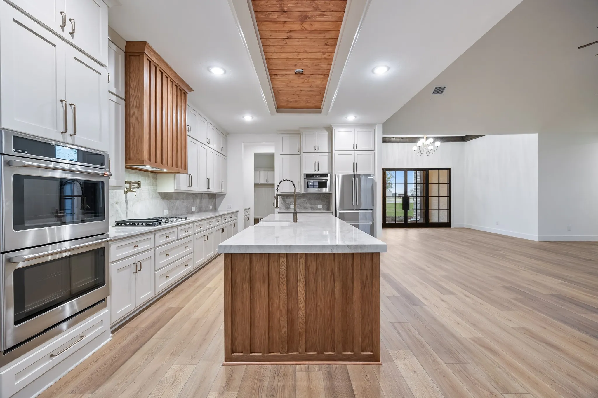 Kitchen with Stainless Steel Double Ovens, cabinets and wood accents!
