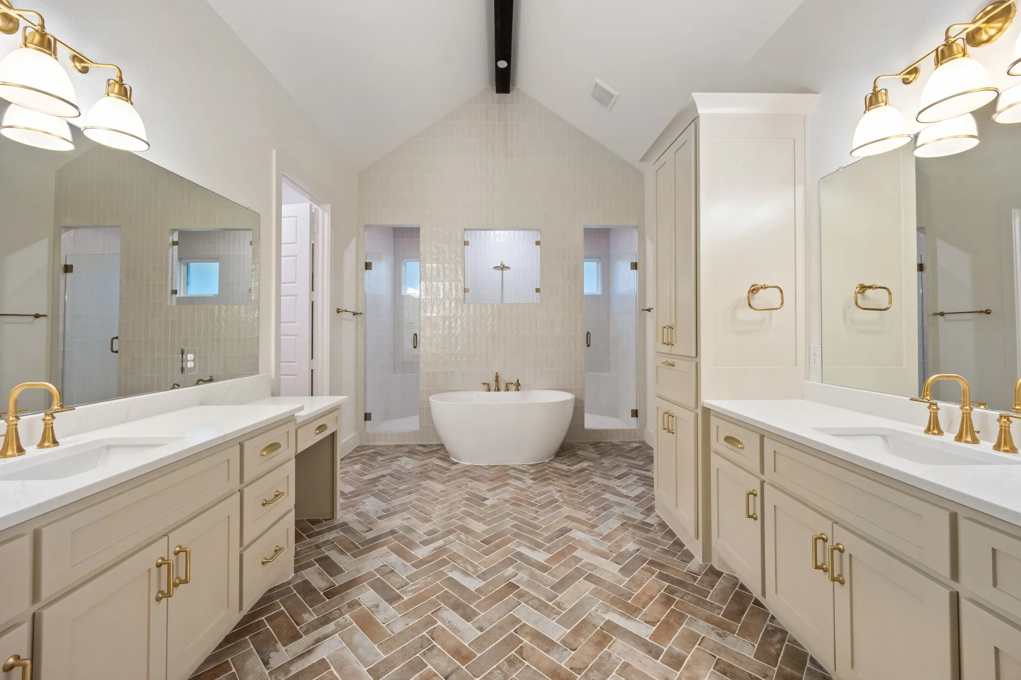 Beautiful & Relaxing Bathroom featuring stall shower, two vanities, decorative flooring, and a soaking tub!