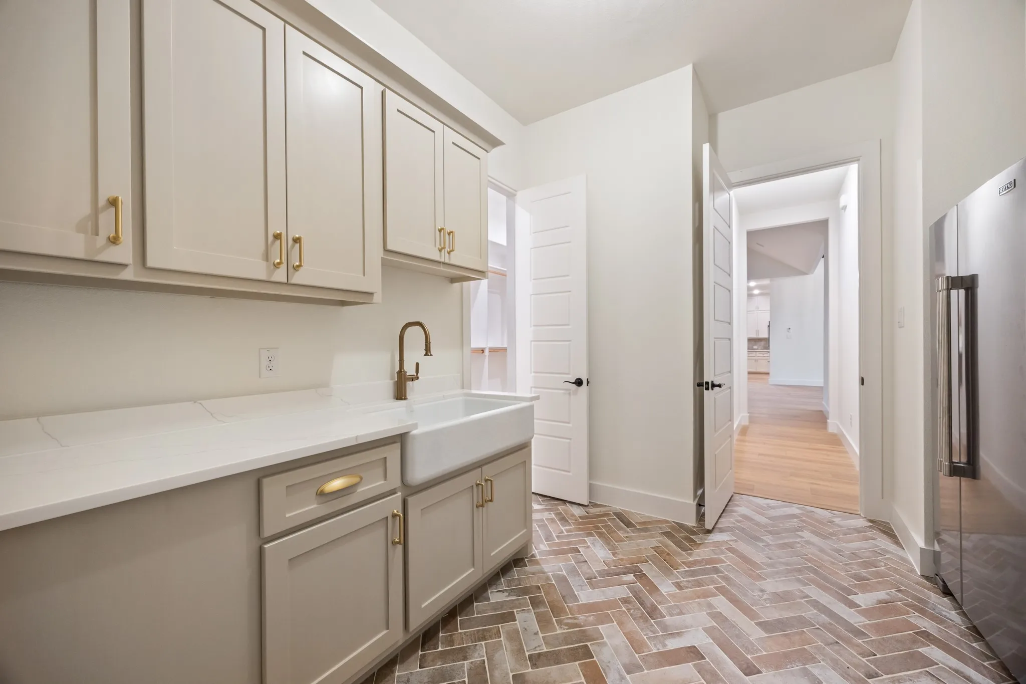 Utility Sink in large Room with Decorative Tiled Flooring plus Stainless Refrigerator!