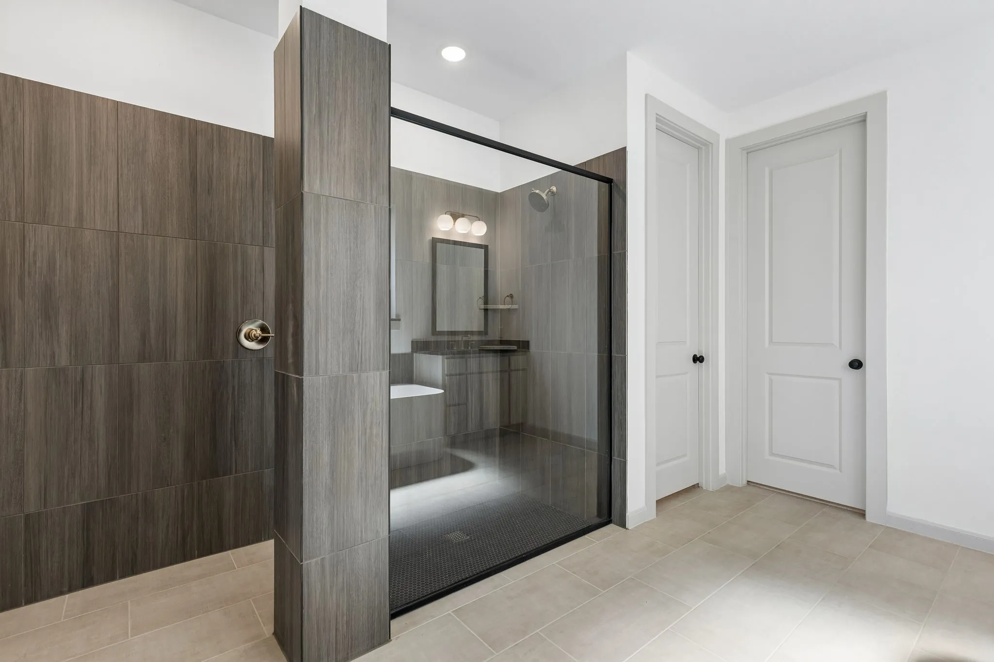 You'll enjoy a spa like experience every day in this spacious owner's bath with free standing tub and walk in shower with drying area!